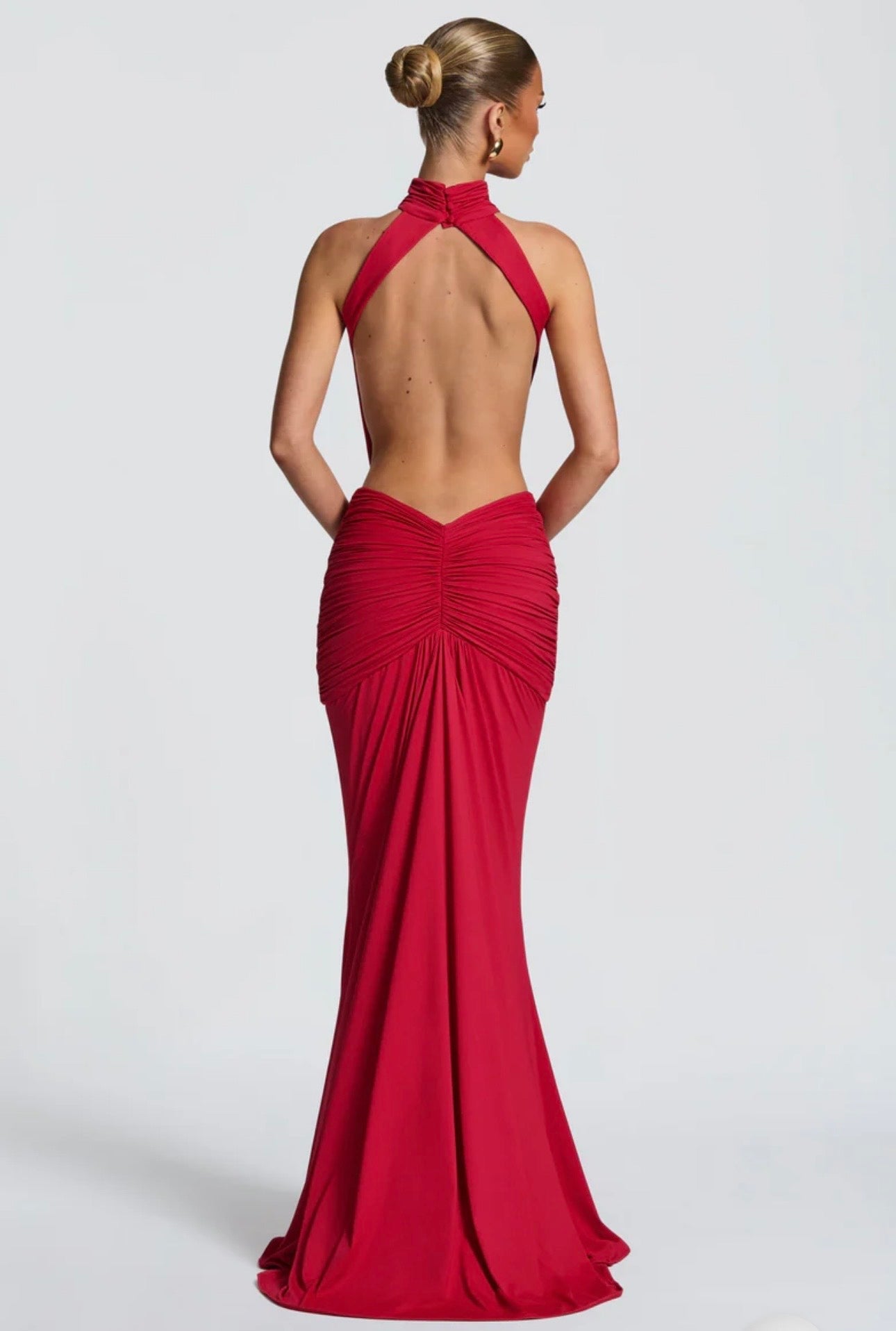 Abito Sofia Caratterizzato da una silhouette a sirena che valorizza le forme, questo modello unisce un sofisticato collo alto a un audace gioco di drappeggi e intagli cut-out sui fianchi.