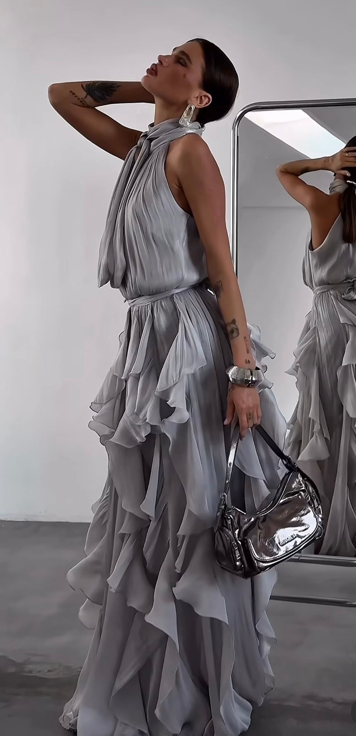 Abito Rouches maxi dress con scollo all'americana, collo con fiocco e gonna a cascata di rouches multistrato pensato per chi vuole essere al centro della scena senza sforzo. La silhouette fluida e il tessuto leggero lo rendono perfetto